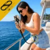 Woman on a boat using a black anti-drop phone lanyard secured to her belt loop with the included S-clip tether