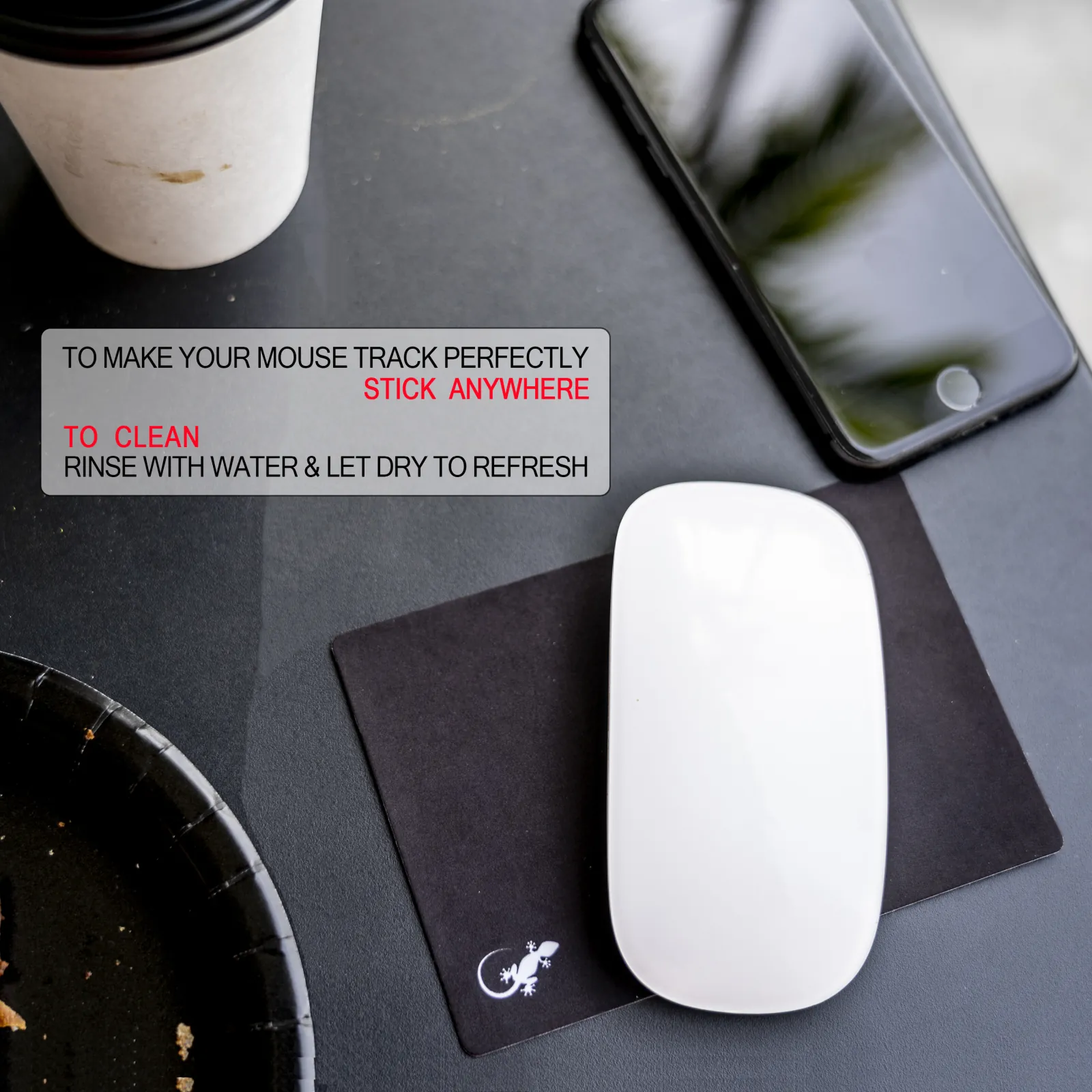 Adhesive travel mouse pad in black and white used with a wireless mouse on an uneven public table surface